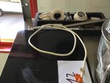 a black table with a white cord on it and a black table with a white cord on it and a black table with a white cord on it