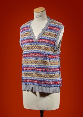 a close up of a mannequin wearing a multicolored sweater