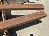 a wooden bench that is sitting on the sidewalk