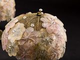 a small purse that has a bunch of flowers on it