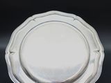a silver plate on a black background