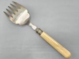 a fork with a wooden handle sitting on a table