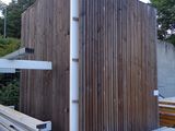 a picture of a building being built with wood siding