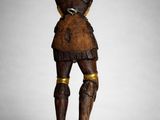 a wooden statue of a man in armor standing on a pedestal