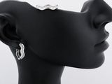 the woman is wearing a pair of earrings that are on the head of a mannequin