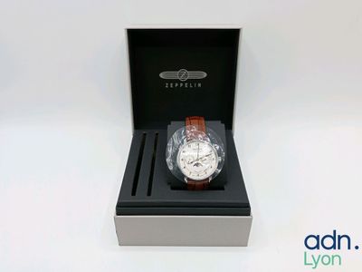 an image of a watch in a box on a white surface