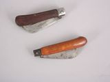 two different types of knives on a white surface