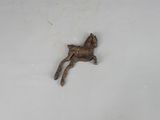 a small bronze statue of a horse on a white surface