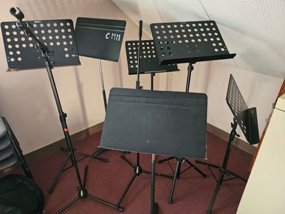 four music stands in the corner of a room