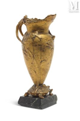 a gold vase that is on a marble base