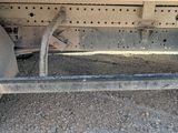 a close up of a flatbed truck with a flat tire