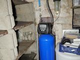 an image of a water softener system in a basement