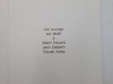 an open book with a picture of a cat sitting on top of it