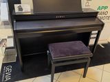 a piano and a stool in a store with a mirror
