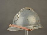 a silver helmet with a brown ribbon on it