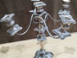 a silver candelab with three candles on it
