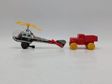 a toy helicopter and a toy truck on a white surface