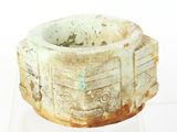 a stone bowl with carvings on it sitting on a table
