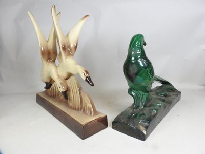 two figurines of birds that are sitting on top of each other