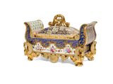 a blue and gold covered box with flowers on it