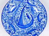 a blue and white plate with an image of a boat on it