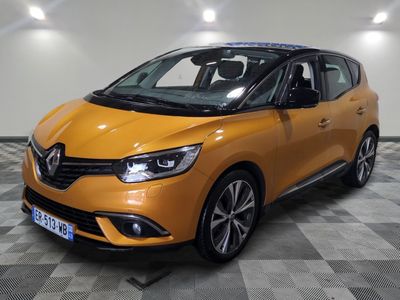 a yellow car is parked in a room with a checkered floor