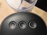 a remote control sitting on a table next to a cup of coffee