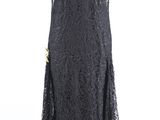 black lace dress on a mannequin stand on a white background