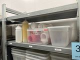 a shelf with containers and containers on it in a kitchen