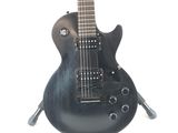 a black electric guitar that is sitting on a stand