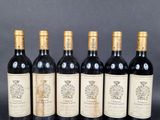 six bottles of wine are lined up in a row