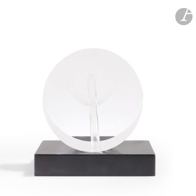 a clear glass sculpture on a black base on a white background