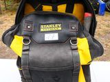 a black and yellow backpack that is on a table