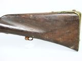 an old rifle with a wooden barrel on a white background