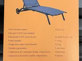 packaging of a blue lounge chair on display in a store window