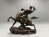 statue of a man riding a horse on a rock with another man on the back
