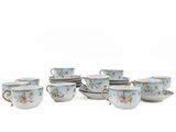 a group of cups and saucers sitting on a table