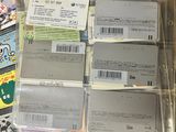 a lot of tickets sitting on a table next to a laptop
