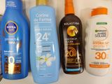 bottles of sunscreen and lotion are lined up on a shelf