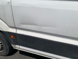a white van that is parked on the side of the road