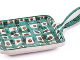 green and white square serving dish with handles