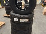 tires are stacked on pallets in a warehouse with pallets in the background