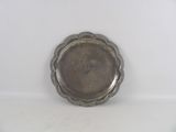 a silver plate with a flower design on it