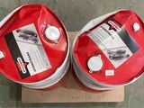 two red drums sitting on top of a cardboard box