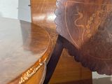 a wooden chair that has been painted with a coat of arms on it
