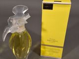 an image of a bottle of perfume sitting next to a box