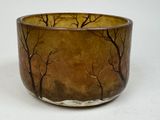 a brown bowl with trees on it on a white surface