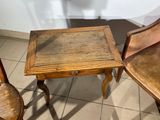 two chairs and a table in a room with tile flooring