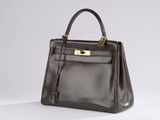 a brown leather handbag on a white background