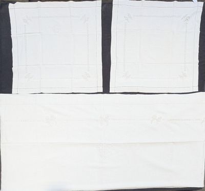 a picture of a bed with two sheets of paper on top of it